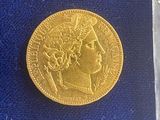 a gold coin sitting on top of a blue cloth