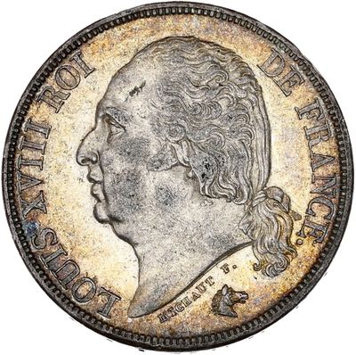 une pièce d'argent représentant la tête d'un homme de profil