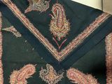 a black shawl with a paisley design on it