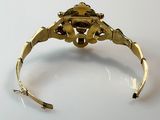 an image of a close up of a gold bracelet on a white surface