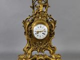 a gold clock that is sitting on a table