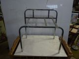 a metal bed frame sitting on top of a wooden box
