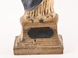 a statue of a man with a hat on a pedestal