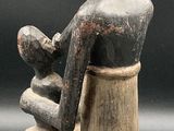 an image of a statue of a man sitting on a chair