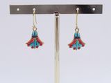 turquoise and red enamel flower earrings on a silver stand