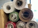 many rolls of yarn in a box on the floor
