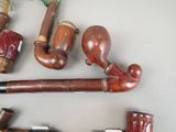 many different types of pipes and pipe holders on the table