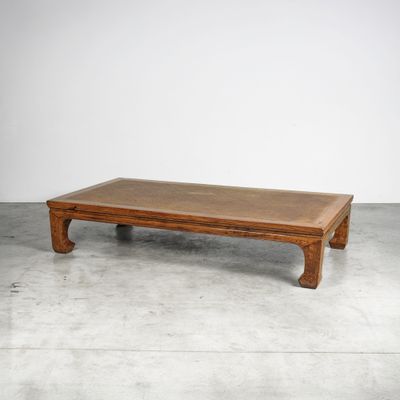 an image of a wooden coffee table on a concrete floor