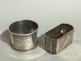 a silver cup and a silver container on a white surface