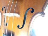 a close up of a violin that is sitting on a table