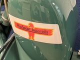 a close up of a green motorcycle with a sticker on it