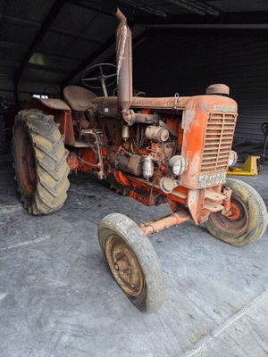 an old tractor that is sitting in a garage