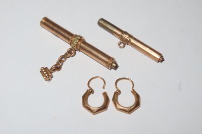 a pair of gold earrings and a pair of gold earrings