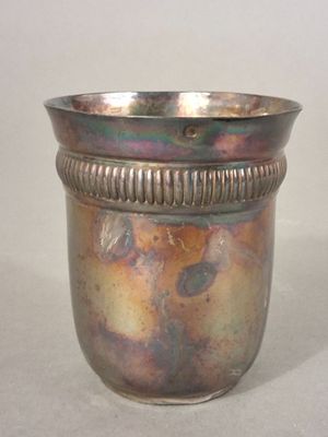 a silver cup that is sitting on a table