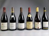 several bottles of wine are lined up on a table
