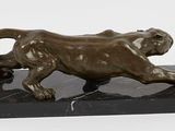 statue of a lion on a marble base on a white background