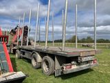 a flatbed truck that is parked in the grass