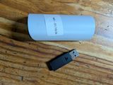 a usb drive next to a bottle of water on a table