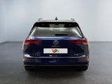 the back of a blue volkswagen vw parked in a white room