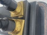 a pair of black and gold candles that are on a table