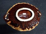 a brown and white plate with a brown and white design on it