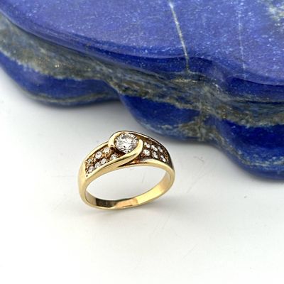 an image of a diamond ring sitting on top of a blue stone