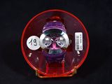 a watch in a plastic case on a black surface