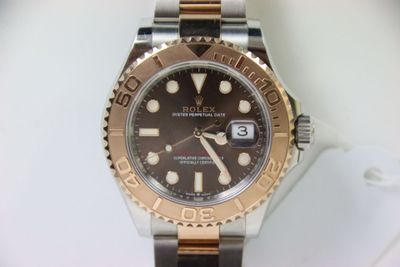 a rolex watch that is on display on a table