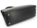 a black leather purse with gold hardware on the front
