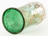 a green glass vase with a gold rim on a white surface