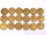 a close up of a pile of gold coins on a white surface