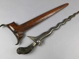 an old knife with a wooden handle sitting on top of a table