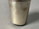 a silver cup that is sitting on a table