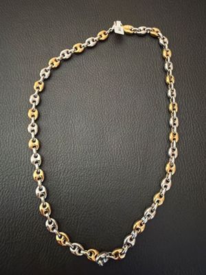 a gold and silver chain necklace with a clasp