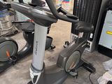 two stationary exercise bikes in a warehouse area