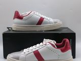 a pair of white and red sneakers sitting on top of a box
