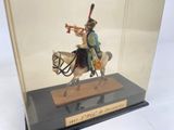 a figurine of a man on a horse with a trumpet