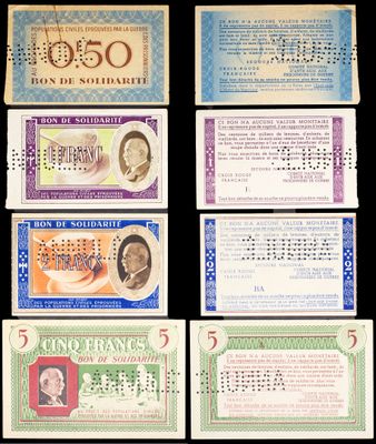 a group of five different bank notes on a black background