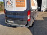 a van parked in front of a building with a sign on the back of it