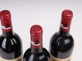 three bottles of wine sitting next to each other on a table