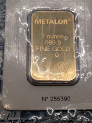 a close up of a gold bar in a package on a table