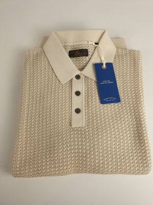 a white sweater with a blue tag on the collar