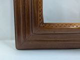a close up of a wooden frame with a white background