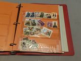 a red binder with stamps on it on a table