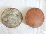 two wooden plates on a table with a newspaper on them