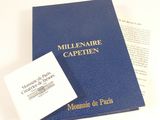 a blue book with a white cover and a card on it