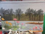 une photo d'un tableau posé sur une table, à côté d'une tasse de café