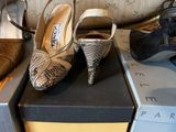 several pairs of women ' s shoes are lined up on boxes