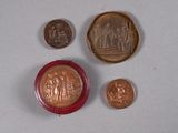 three coins and a coin sitting on a table