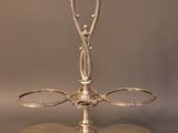 a silver plate with a handle on it on a table